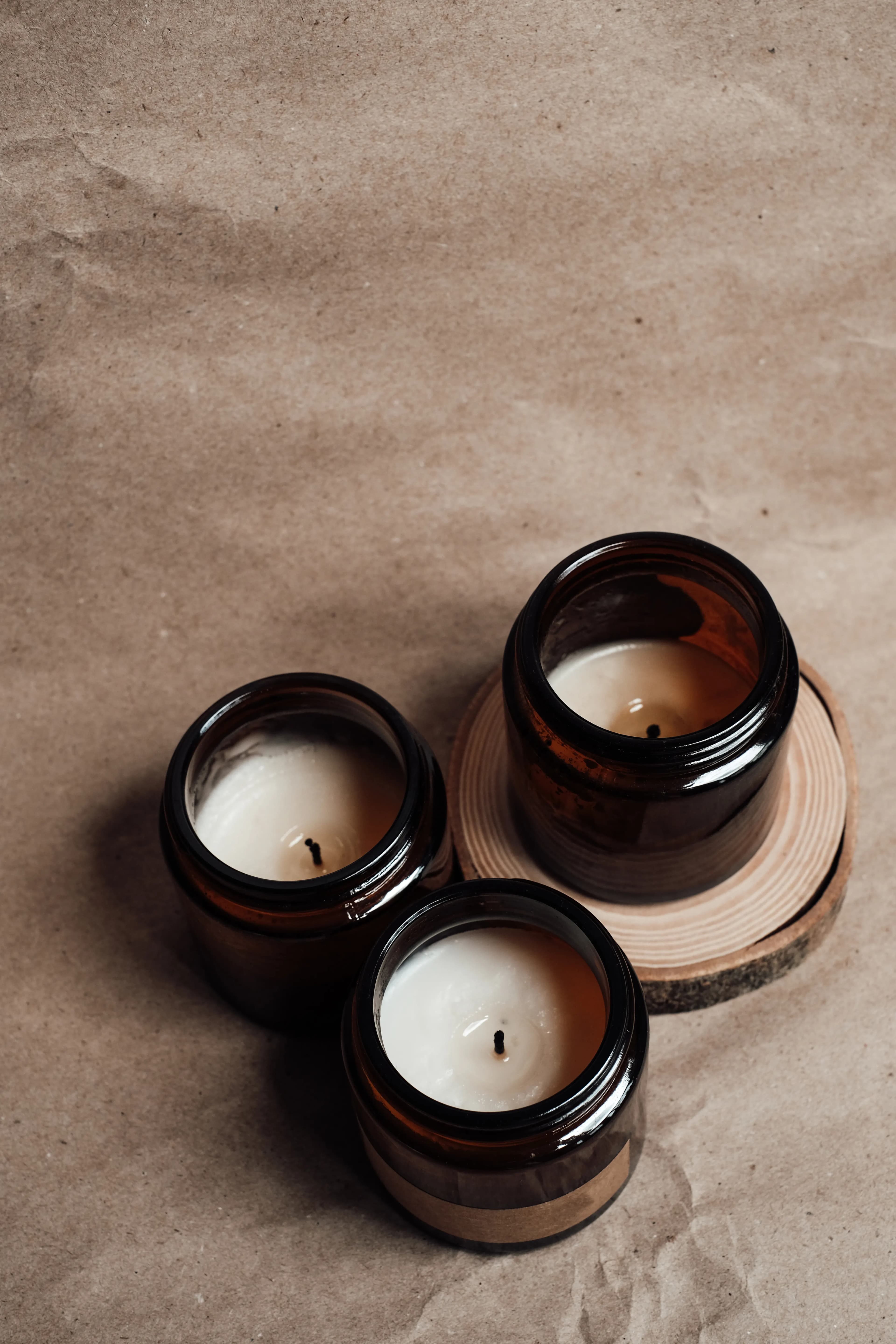 A hand-poured candle styled among natural greenery